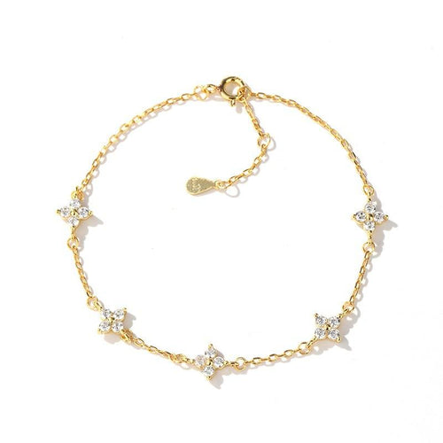 Gold bracelet with star-shaped charms on a white background