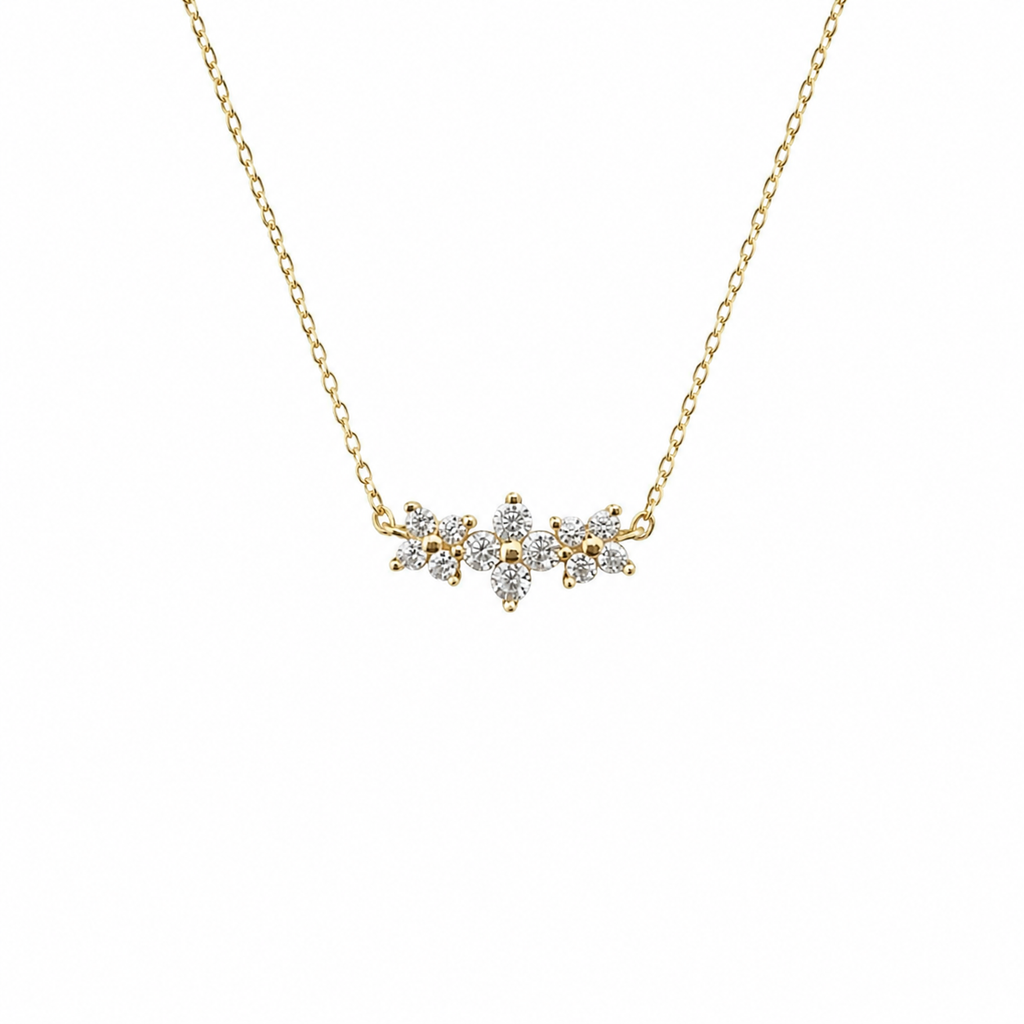 Gold necklace with a diamond pendant on a white background