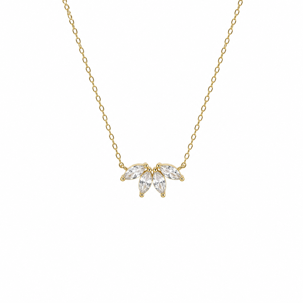 Gold necklace with a leaf-shaped pendant on a white background