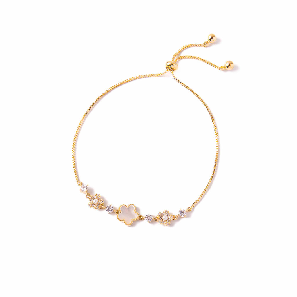 Gold bracelet with floral design on a white background