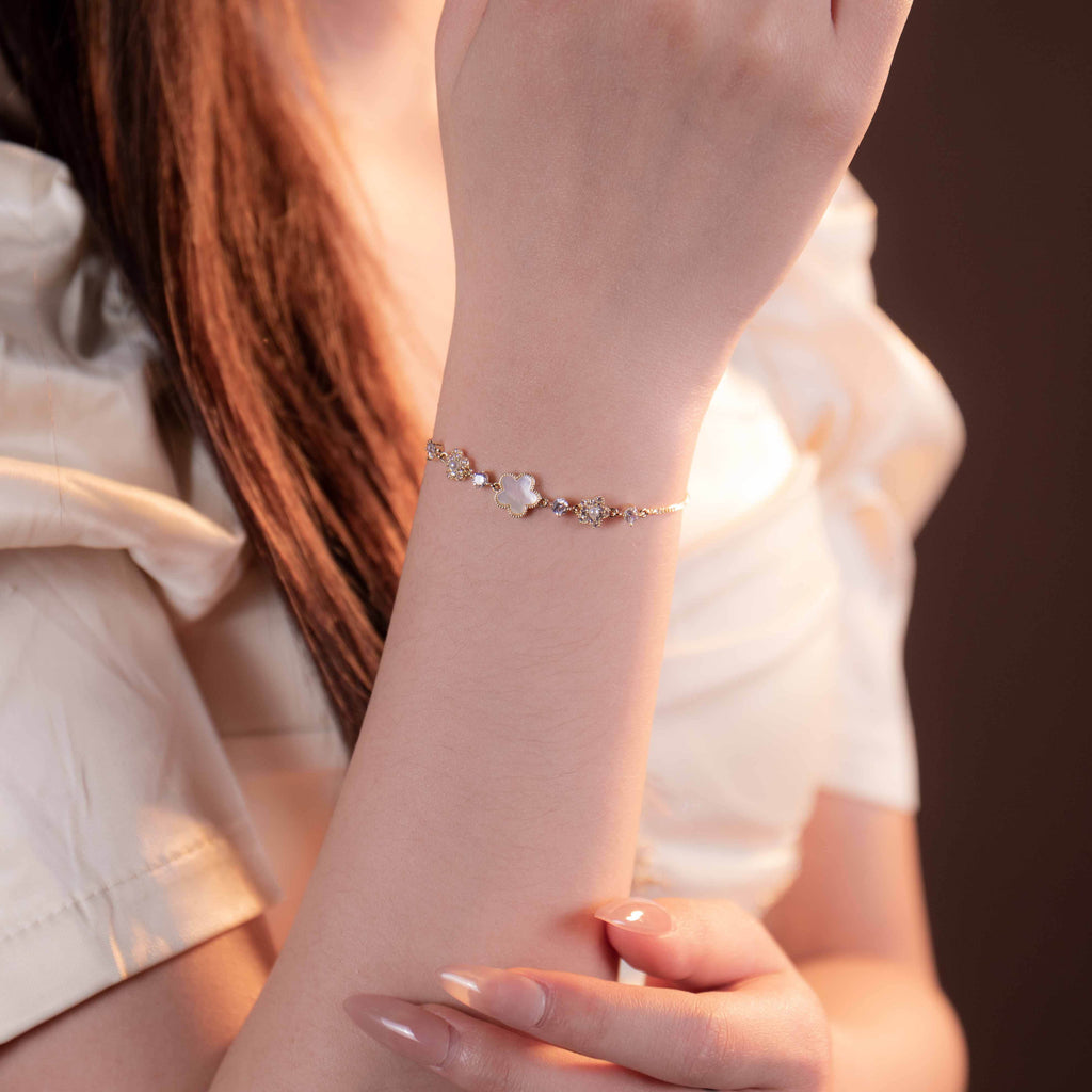 Close-up of a person wearing a delicate bracelet on a blurred background