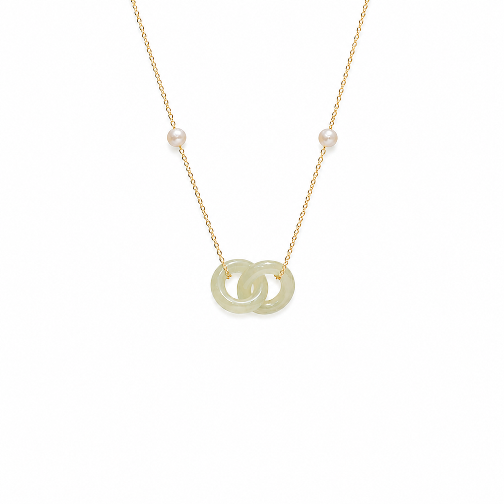 Gold necklace with a jade pendant on a white background